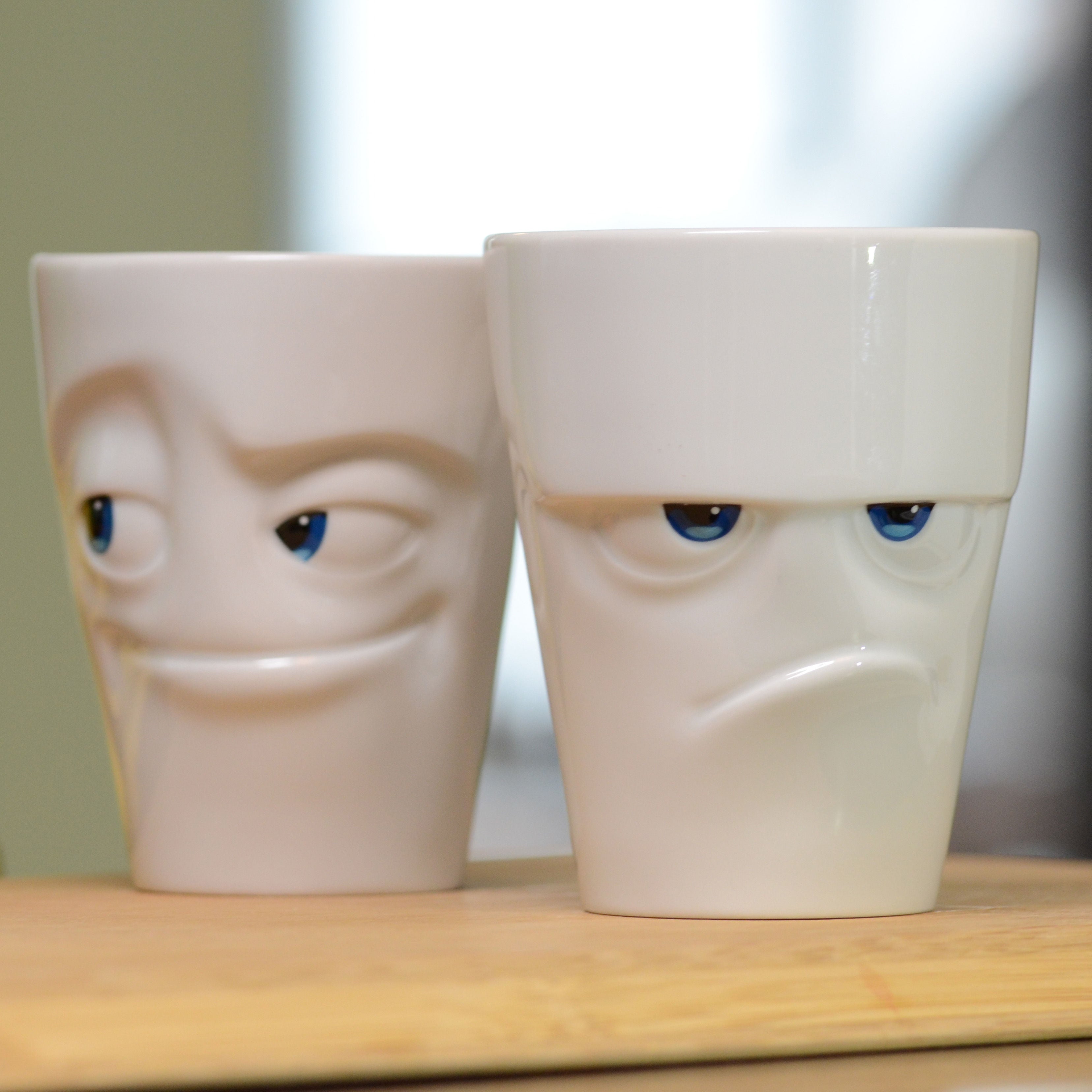 Premium porcelain coffee mug with handle from the popular porcelain family of fun dishware by FIFTYEIGHT Products. Special art edition with colorful accents applied by hand. Offers 11 oz capacity for serving coffee, tea, latte, matcha, soup and more. Dishwasher and microwave safe cup with a 'grumpy' facial expression. Shipped in exclusively designed gift box.