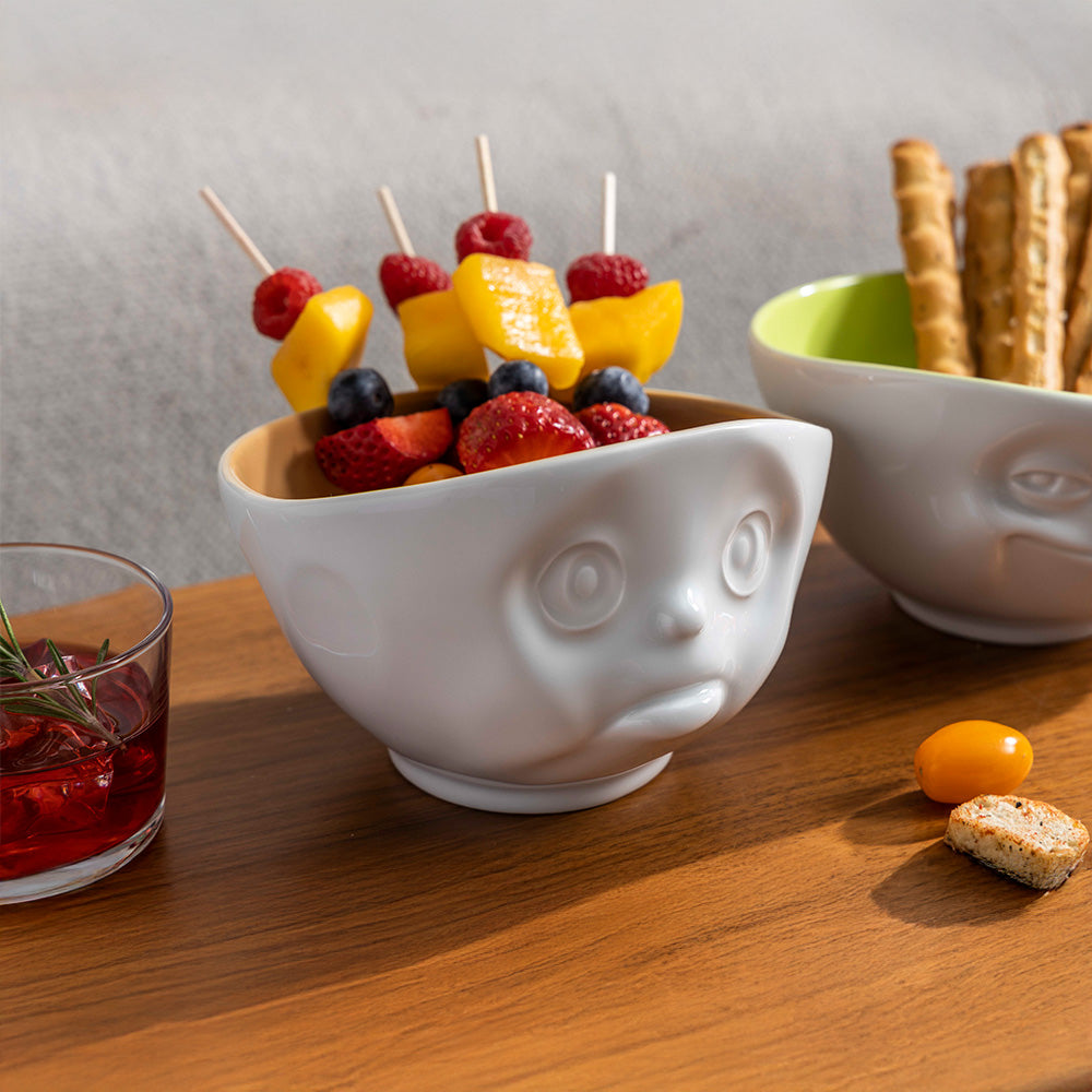 Premium porcelain bowl in white with sand color on the inside from the porcelain product family by FIFTYEIGHT Products. Offers 16oz capacity perfect for serving cereal, soup, snacks and much more. Dishwasher and microwave safe bowl featuring a sculpted ‘sulking’ facial expression. Shipped in exclusively designed gift box.