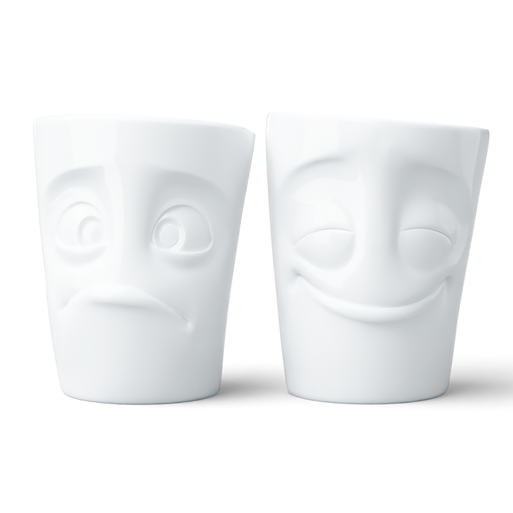Set of two coffee mugs without handles in white from the porcelain product family of fun dishware by FIFTYEIGHT Products. Each offering 11 oz capacity. Dishwasher and microwave safe coffee cups with 'Cheery' and 'Baffled' facial expression. Shipped in exclusively designed gift box.