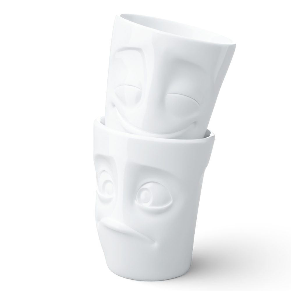 Set of two coffee mugs without handles in white from the porcelain product family of fun dishware by FIFTYEIGHT Products. Each offering 11 oz capacity. Dishwasher and microwave safe coffee cups with 'Cheery' and 'Baffled' facial expression. Shipped in exclusively designed gift box.