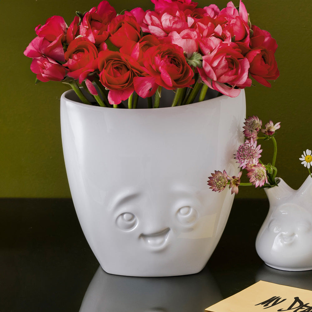 Exclusive designer flower vase made from premium porcelain with a 'delighted' facial expression. Stands at 6.5 inches tall on a footed base. From the popular product family of fun dishware by FIFTYEIGHT Products. Made in Germany according to environmental standards.