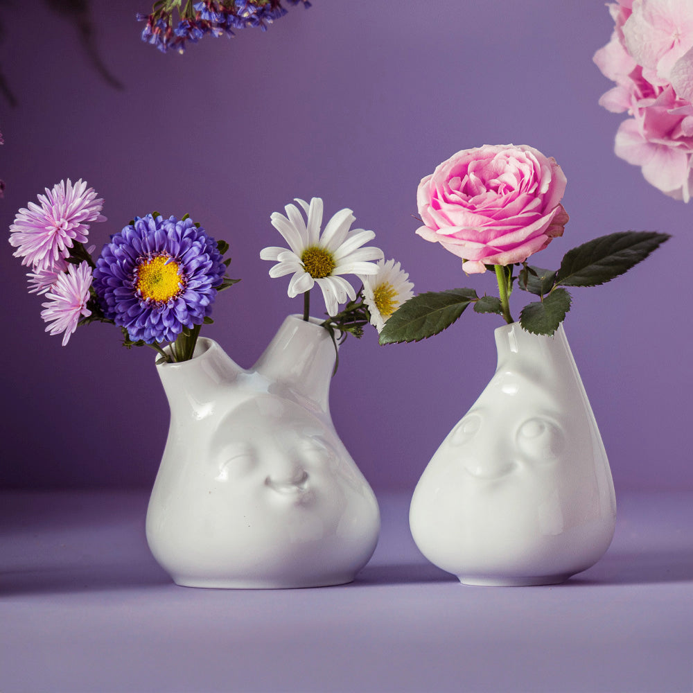 Exclusive designer flower vase made from premium porcelain with a 'cheeky' facial expression. Stands at 3.9 inches tall on a footed base. From the porcelain product family of fun dishware by FIFTYEIGHT Products. Made in Germany according to environmental standards.