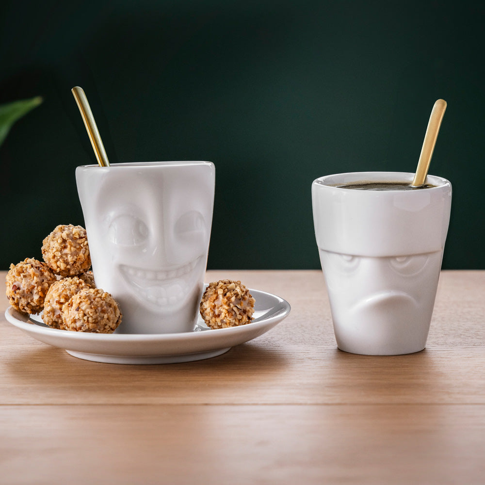 Premium porcelain espresso cup with saucer in white from the porcelain product family of fun dishware by FIFTYEIGHT Products. Offers 2.7 oz capacity and comes with a matching saucer. Dishwasher and microwave safe cup with a 'joking' facial expression. Shipped in exclusively designed gift box.