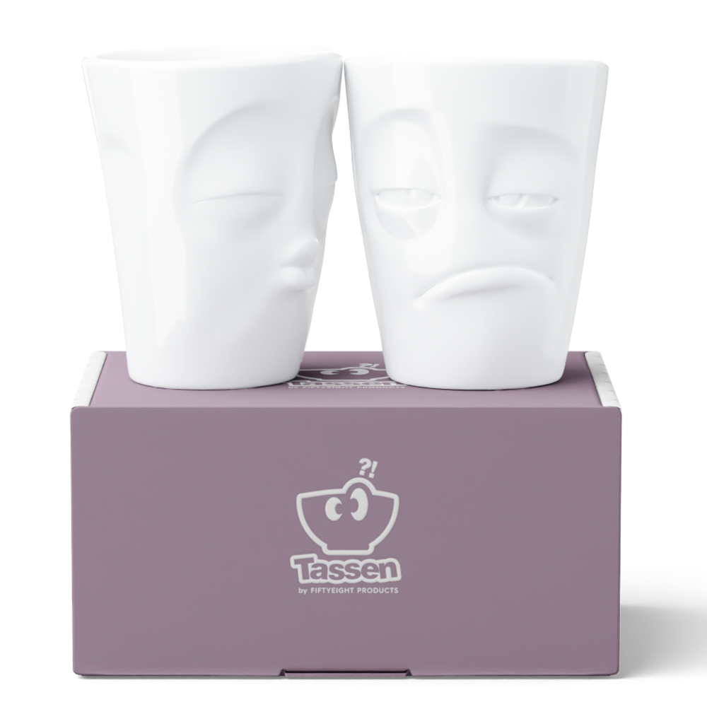 Set of two coffee mugs without handles in white from the porcelain product family of fun dishware by FIFTYEIGHT Products. Each offering 11 oz capacity. Dishwasher and microwave safe coffee cups with a 'snoozy' and one with a 'kissing' facial expression. Shipped in exclusively designed gift box.