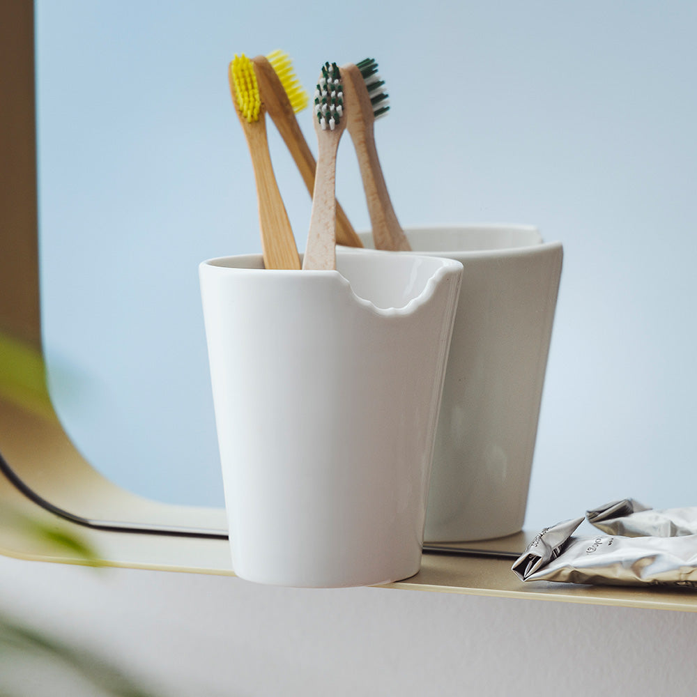 Premium porcelain coffee mug with a 'bite' mark and no handle from the porcelain product family of fun dishware by FIFTYEIGHT Products. Offers 13.5 oz capacity for serving coffee, tea, latte, matcha, soup and more. Dishwasher and microwave safe. Shipped in exclusively designed gift box.