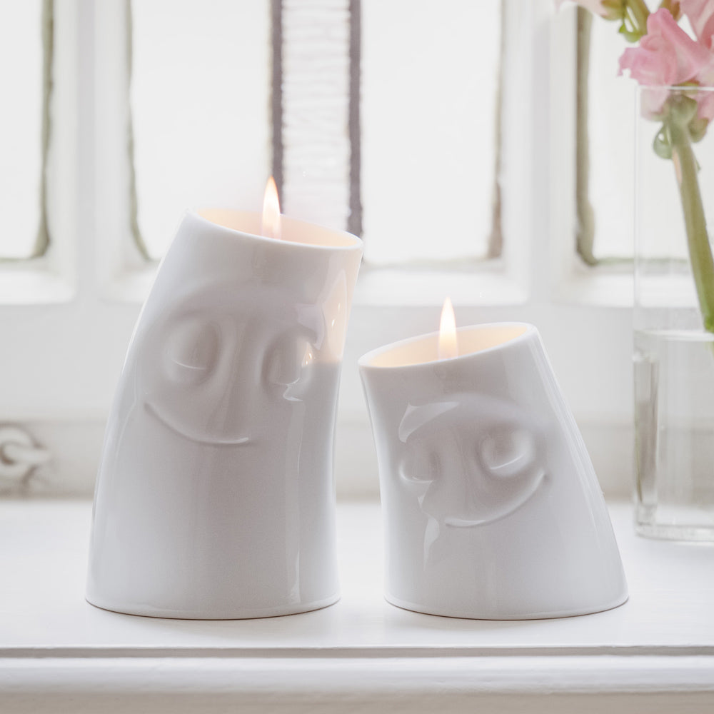 Exclusive designer candle holder with CUDDLY facial expression. Stands at 4.4 inches tall on a footed base and fits a tea light or LED light. From the TASSEN product family of fun dishware by FIFTYEIGHT Products. Made in Germany according to environmental standards.