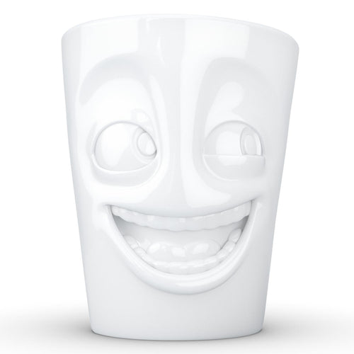 Coffee mug with 'joking' facial expression and 11 oz capacity. From the TASSEN product family of fun dishware by FIFTYEIGHT Products. Tall coffee cup with handle in white, crafted from quality porcelain.