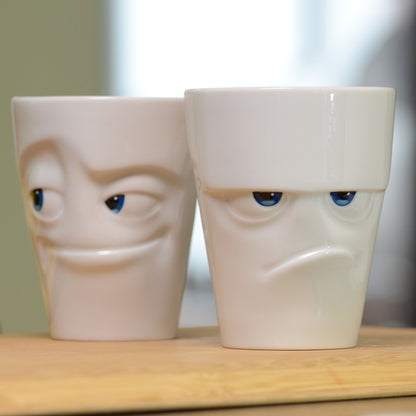 Premium porcelain coffee mug with handle from the popular porcelain family of fun dishware by FIFTYEIGHT Products. Special art edition with colorful accents applied by hand. Offers 11 oz capacity for serving coffee, tea, latte, matcha, soup and more. Dishwasher and microwave safe cup with a 'grumpy' facial expression. Shipped in exclusively designed gift box.