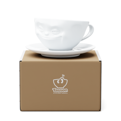 Premium porcelain coffee cup with saucer in white from the porcelain product family of fun dishware by FIFTYEIGHT Products. Offers 6.5 oz capacity and comes with a matching saucer. Dishwasher and microwave safe cup with a 'grinning' facial expression. Shipped in exclusively designed gift box.