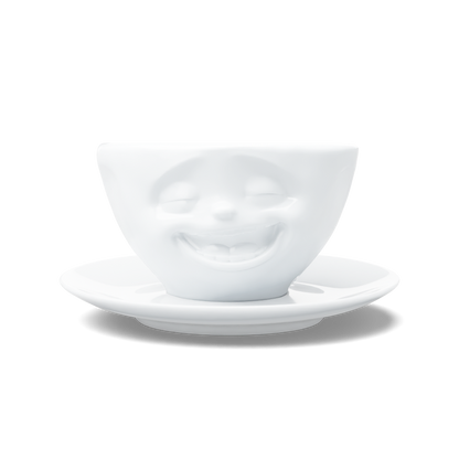 Premium porcelain coffee cup with saucer in white from the porcelain product family of fun dishware by FIFTYEIGHT Products. Offers 6.5 oz capacity and comes with a matching saucer. Dishwasher and microwave safe cup with a 'laughing' facial expression. Shipped in exclusively designed gift box.