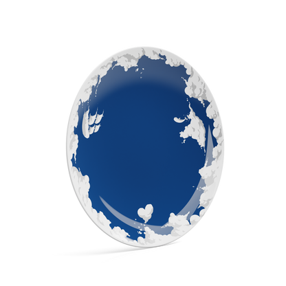 Porcelain dinner plate in featuring elaborate blue artwork with clouds and sailboats with 11 inch diameter. Premium porcelain in hotel quality, from the TASSEN product family of fun dishware by FIFTYEIGHT Products.