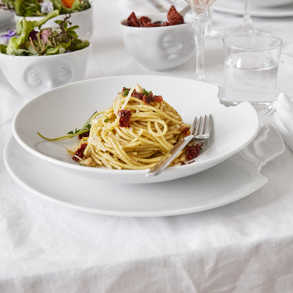 Set of two premium porcelain dinner plates in white with a 'bite mark' cutout at the edge. Dishwasher and microwave safes plate with a 11 inch diameter. From the porcelain product family of fun dishware by FIFTYEIGHT Products. Made in Germany according to environmental standards.