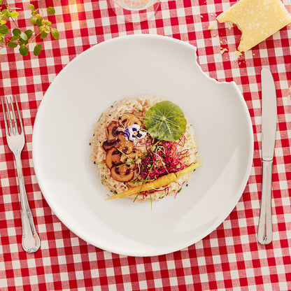 Set of two premium porcelain dinner plates in white with a 'bite mark' cutout at the edge. Dishwasher and microwave safes plate with a 11 inch diameter. From the porcelain product family of fun dishware by FIFTYEIGHT Products. Made in Germany according to environmental standards.