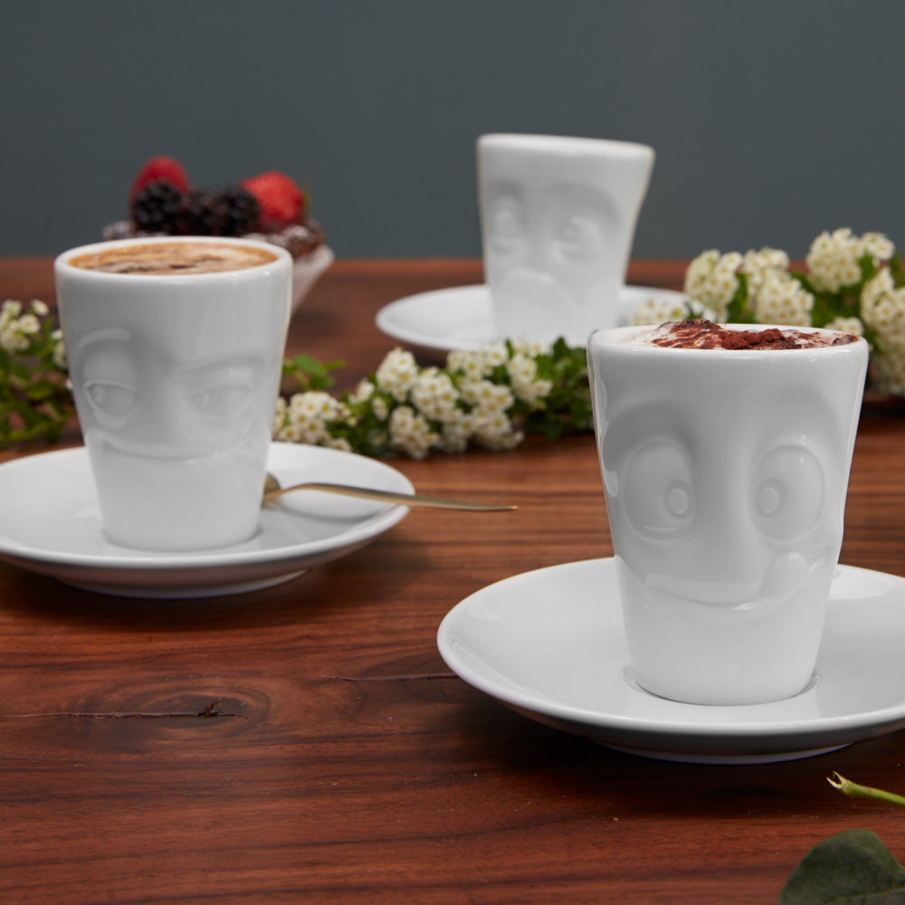 Premium porcelain espresso cup with saucer in white from the porcelain product family of fun dishware by FIFTYEIGHT Products. Offers 2.7 oz capacity and comes with a matching saucer. Dishwasher and microwave safe cup with a 'tasty' facial expression. Shipped in exclusively designed gift box.