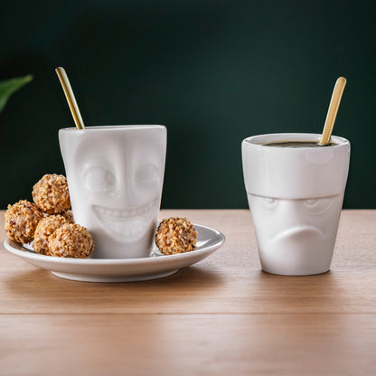Premium porcelain espresso cup with saucer in white from the porcelain product family of fun dishware by FIFTYEIGHT Products. Offers 2.7 oz capacity and comes with a matching saucer. Dishwasher and microwave safe cup with a 'joking' facial expression. Shipped in exclusively designed gift box.
