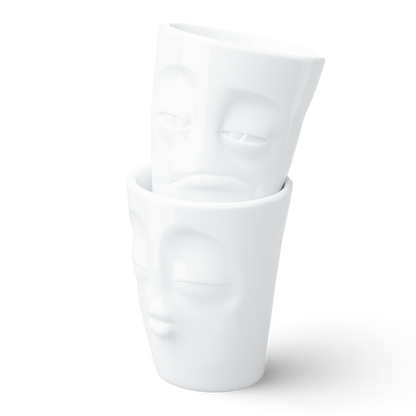 Set of two coffee mugs without handles in white from the porcelain product family of fun dishware by FIFTYEIGHT Products. Each offering 11 oz capacity. Dishwasher and microwave safe coffee cups with a 'snoozy' and one with a 'kissing' facial expression. Shipped in exclusively designed gift box.