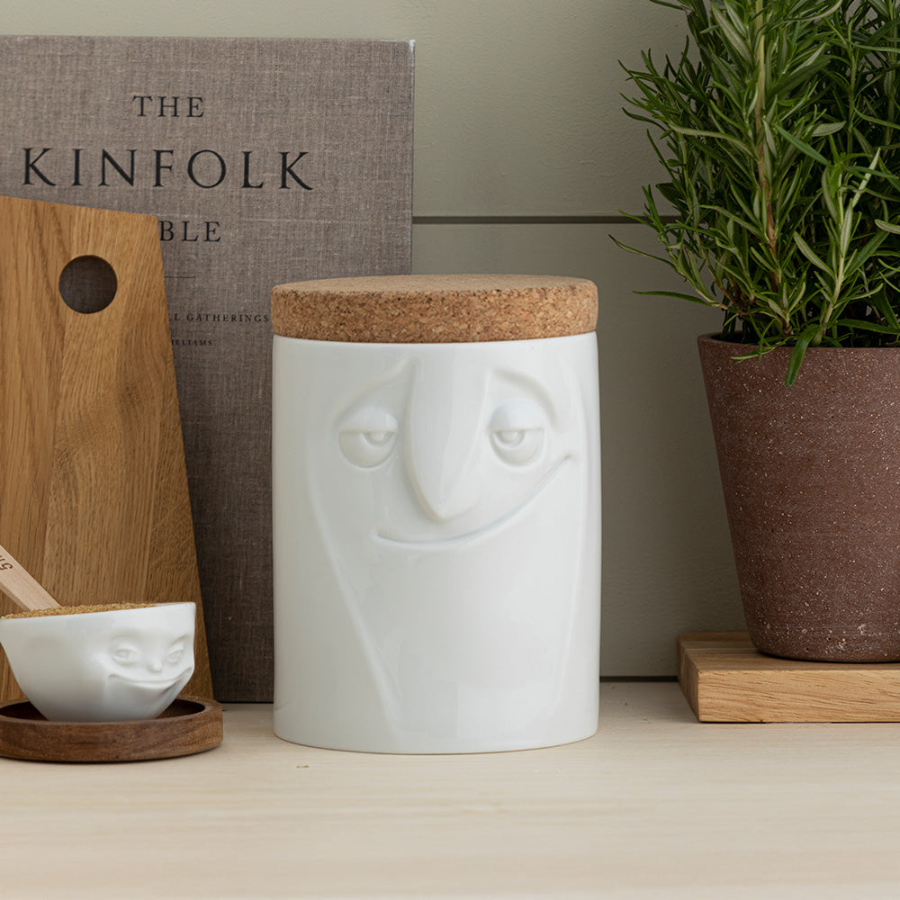 Quality porcelain storage jar with 57 oz. capacity and a 'charming' facial expression. Closes securely with a natural cork lid. Dishwasher and microwave-safe (except for cork lid).From the porcelain product family of fun dishware by FIFTYEIGHT Products. Made in Germany according to environmental standards.standards.