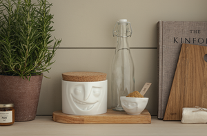Quality porcelain storage jar with 30 oz. capacity and a 'cheerful' facial expression. Closes securely with a natural cork lid. Dishwasher and microwave-safe (except for cork lid).From the TASSEN product family of fun dishware by FIFTYEIGHT Products. Made in Germany according to environmental standards.standards.