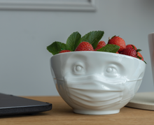 Load image into Gallery viewer, Premium porcelain bowl in white from the TASSEN product family of fun dishware by FIFTYEIGHT Products. Offers 16 oz capacity perfect for serving cereal, soup, snacks and much more. Dishwasher and microwave safe bowl featuring a sculpted ‘hopeful’ facial expression and mask. Shipped in exclusively designed gift box.
