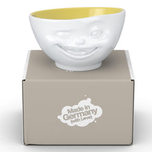 Load image into Gallery viewer, Premium porcelain bowl in white with Saffron Color Inside from the TASSEN product family of fun dishware by FIFTYEIGHT Products. Offers 16 oz capacity perfect for serving cereal, soup, snacks and much more. Dishwasher and microwave safe bowl featuring a sculpted ‘winking’ facial expression. Shipped in exclusively designed gift box.
