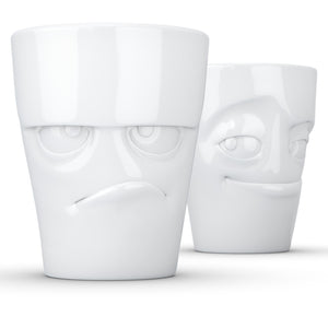 Set of two coffee mugs with 'Grumpy' and 'Impish' facial expression and 11 oz capacity. From the TASSEN product family of fun dishware by FIFTYEIGHT Products. Tall coffee cups without handles in white, crafted from quality porcelain.