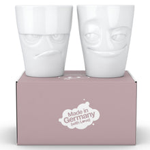 Load image into Gallery viewer, Set of two coffee mugs with &#39;Grumpy&#39; and &#39;Impish&#39; facial expression and 11 oz capacity. From the TASSEN product family of fun dishware by FIFTYEIGHT Products. Tall coffee cups without handles in white, crafted from quality porcelain.
