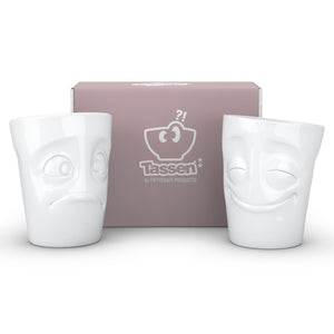 Set of two coffee mugs with 'Cheery' and 'Baffled' facial expression and 11 oz capacity. From the TASSEN product family of fun dishware by FIFTYEIGHT Products. Tall coffee cups without handles in white, crafted from quality porcelain.