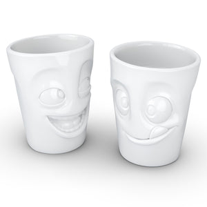 Set of two coffee mugs with 'joking' and 'tasty' facial expression and 11 oz capacity. From the TASSEN product family of fun dishware by FIFTYEIGHT Products. Tall coffee cups without handles in white, crafted from quality porcelain.