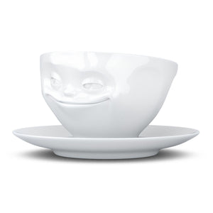 Coffee cup with a 'grinning' facial expression and 6.5 oz capacity. From the TASSEN product family of fun dishware by FIFTYEIGHT Products. Coffee cup with matching saucer crafted from quality porcelain.