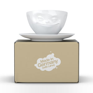 Coffee cup with a 'grinning' facial expression and 6.5 oz capacity. From the TASSEN product family of fun dishware by FIFTYEIGHT Products. Coffee cup with matching saucer crafted from quality porcelain.