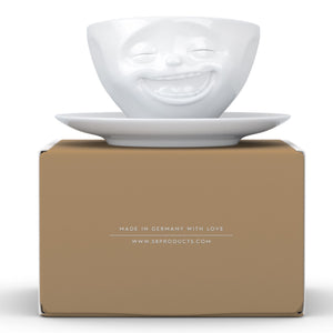 Coffee cup with a 'laughing' facial expression and 6.5 oz capacity. From the TASSEN product family of fun dishware by FIFTYEIGHT Products. Coffee cup with matching saucer crafted from quality porcelain.