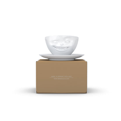 Coffee cup with a 'winking' facial expression and 6.5 oz capacity. From the TASSEN product family of fun dishware by FIFTYEIGHT Products. Coffee cup with matching saucer crafted from quality porcelain.