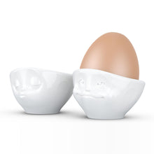 Load image into Gallery viewer, Set of two egg cups in white from the TASSEN product family of fun dishware by FIFTYEIGHT Products. Set features two egg cups in white, featuring &#39;kissing&#39; and &#39;dreamy&#39; facial expressions. Dishwasher and microwave safe bowls. Shipped in exclusively designed gift box.
