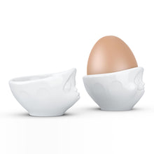 Load image into Gallery viewer, Set of two egg cups in white from the TASSEN product family of fun dishware by FIFTYEIGHT Products. Set features two egg cups in white, featuring &#39;kissing&#39; and &#39;dreamy&#39; facial expressions. Dishwasher and microwave safe bowls. Shipped in exclusively designed gift box.
