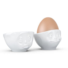 Load image into Gallery viewer, Set of two egg cups in white from the TASSEN product family of fun dishware by FIFTYEIGHT Products. Set features two egg cups in white, featuring &#39;Oh please&#39; and &#39;tasty&#39; facial expressions. Dishwasher and microwave safe bowls. Shipped in exclusively designed gift box.
