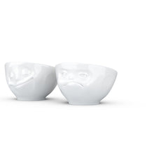 Load image into Gallery viewer, Set of two egg cups in white from the TASSEN product family of fun dishware by FIFTYEIGHT Products. Set features two egg cups in white, featuring &#39;Happy&#39; and &#39;Hmpff&#39; facial expressions. Dishwasher and microwave safe bowls. Shipped in exclusively designed gift box.

