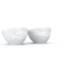 Load image into Gallery viewer, Set of two egg cups in white from the TASSEN product family of fun dishware by FIFTYEIGHT Products. Set features two egg cups in white, featuring &#39;Happy&#39; and &#39;Hmpff&#39; facial expressions. Dishwasher and microwave safe bowls. Shipped in exclusively designed gift box.
