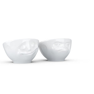 Set of two egg cups in white from the TASSEN product family of fun dishware by FIFTYEIGHT Products. Set features two egg cups in white, featuring 'Happy' and 'Hmpff' facial expressions. Dishwasher and microwave safe bowls. Shipped in exclusively designed gift box.