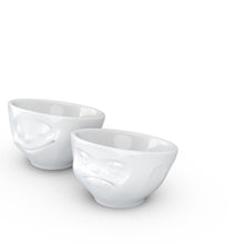 Load image into Gallery viewer, Set of two egg cups in white from the TASSEN product family of fun dishware by FIFTYEIGHT Products. Set features two egg cups in white, featuring &#39;Happy&#39; and &#39;Hmpff&#39; facial expressions. Dishwasher and microwave safe bowls. Shipped in exclusively designed gift box.
