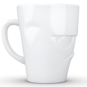 Coffee mug with 'grumpy' facial expression and 11 oz capacity. From the TASSEN product family of fun dishware by FIFTYEIGHT Products. Tall coffee cup with handle in white, crafted from quality porcelain.