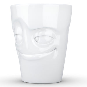 Coffee mug with 'impish' facial expression and 11 oz capacity. From the TASSEN product family of fun dishware by FIFTYEIGHT Products. Tall coffee cup with handle in white, crafted from quality porcelain.