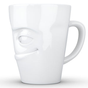 Coffee mug with 'impish' facial expression and 11 oz capacity. From the TASSEN product family of fun dishware by FIFTYEIGHT Products. Tall coffee cup with handle in white, crafted from quality porcelain.