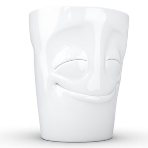 Coffee mug with 'cheery' facial expression and 11 oz capacity. From the TASSEN product family of fun dishware by FIFTYEIGHT Products. Tall coffee cup with handle in white, crafted from quality porcelain.