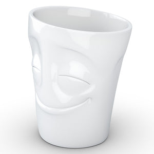 Coffee mug with 'cheery' facial expression and 11 oz capacity. From the TASSEN product family of fun dishware by FIFTYEIGHT Products. Tall coffee cup with handle in white, crafted from quality porcelain.