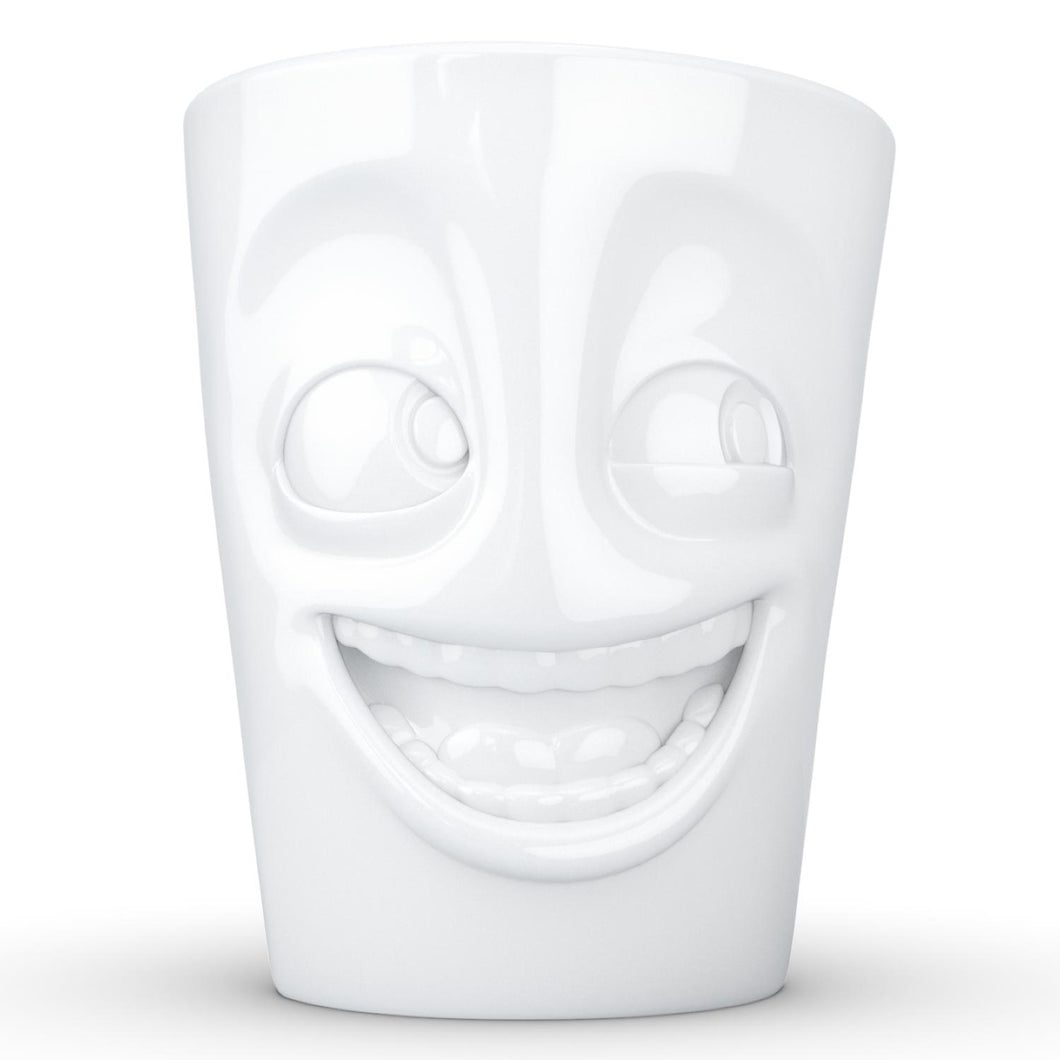 Coffee mug with 'joking' facial expression and 11 oz capacity. From the TASSEN product family of fun dishware by FIFTYEIGHT Products. Tall coffee cup with handle in white, crafted from quality porcelain.