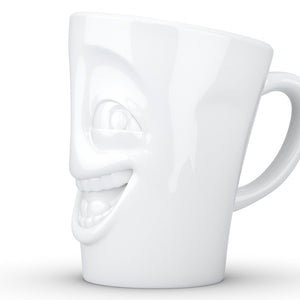 Coffee mug with 'joking' facial expression and 11 oz capacity. From the TASSEN product family of fun dishware by FIFTYEIGHT Products. Tall coffee cup with handle in white, crafted from quality porcelain.