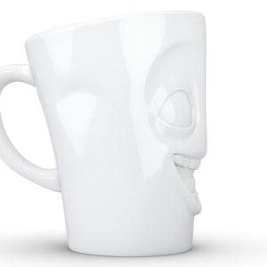 Coffee mug with 'joking' facial expression and 11 oz capacity. From the TASSEN product family of fun dishware by FIFTYEIGHT Products. Tall coffee cup with handle in white, crafted from quality porcelain.