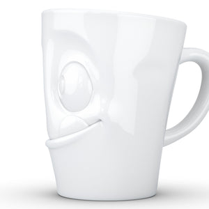 Coffee mug with 'tasty' facial expression and 11 oz capacity. From the TASSEN product family of fun dishware by FIFTYEIGHT Products. Tall coffee cup with handle in white, crafted from quality porcelain.