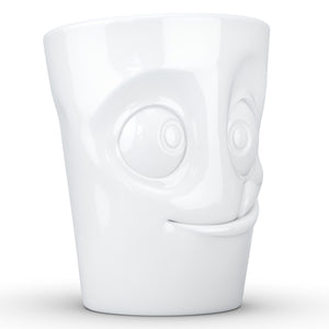 Coffee mug with 'tasty' facial expression and 11 oz capacity. From the TASSEN product family of fun dishware by FIFTYEIGHT Products. Tall coffee cup with handle in white, crafted from quality porcelain.