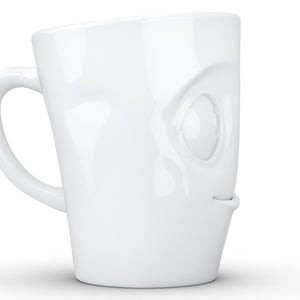 Coffee mug with 'tasty' facial expression and 11 oz capacity. From the TASSEN product family of fun dishware by FIFTYEIGHT Products. Tall coffee cup with handle in white, crafted from quality porcelain.